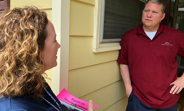 AEMA employee visiting a storm victim